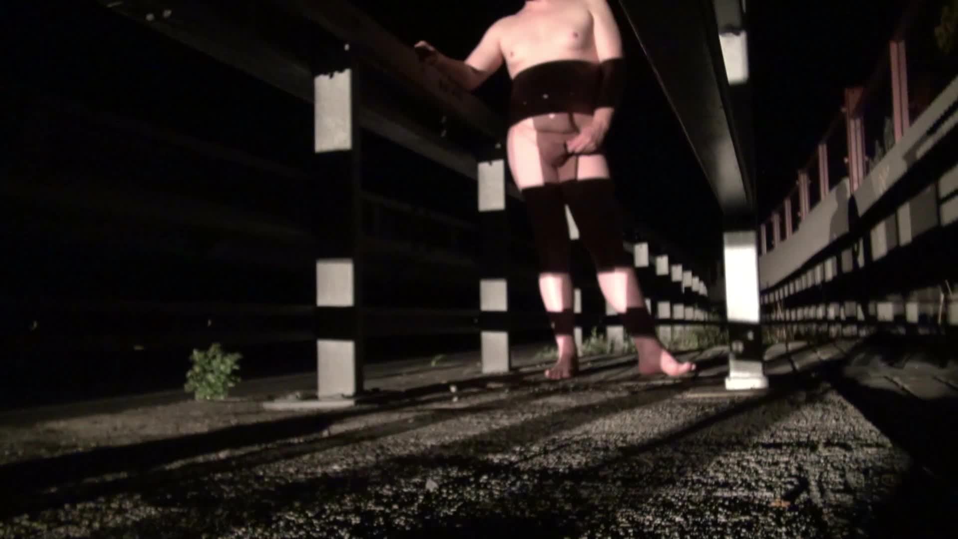 Naked beside the Autobahn at night, exposed in plain sight and illuminated bright by high-power beams of passing trucks.