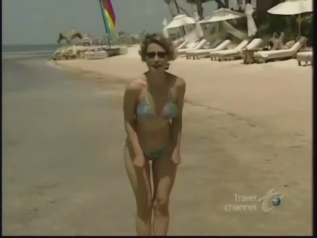 Samantha Brown (travel channel host) bouncing out of frame in a string bikini