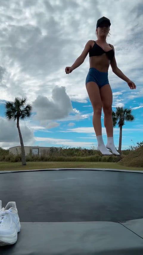 the athletic lady likes to jump on the trampoline.