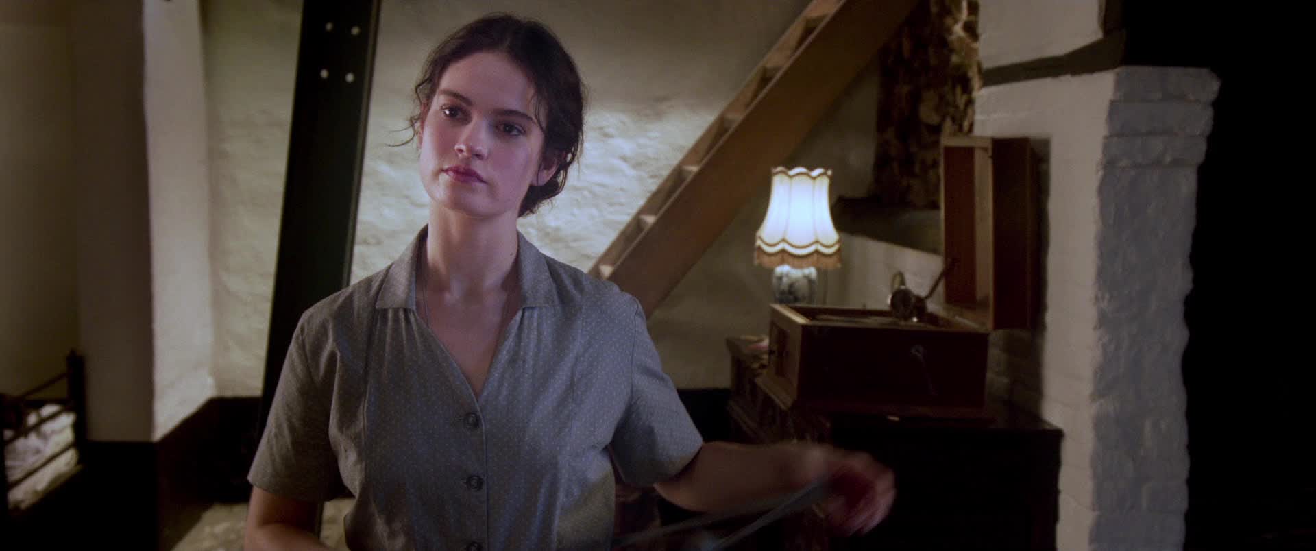 Lily James strips and bends over a table