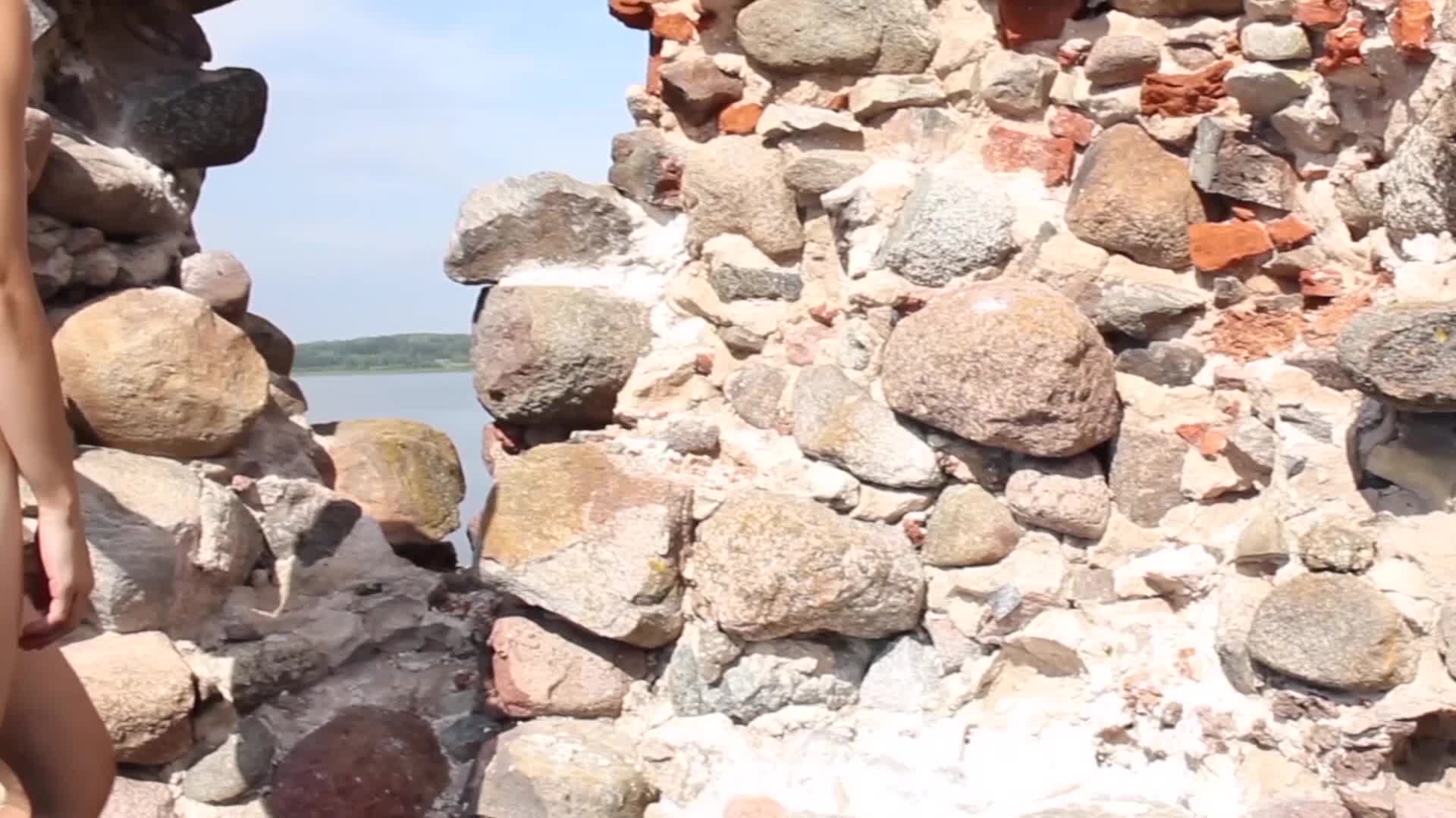 Naked And Cautious At The Castle Ruins While Tourists Are Behind The Wall