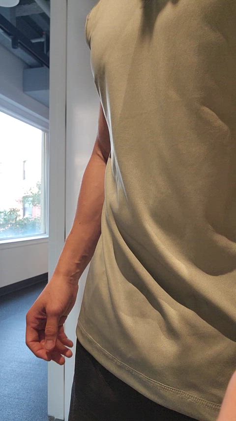 Undressing with door open at the gym in front of a window
