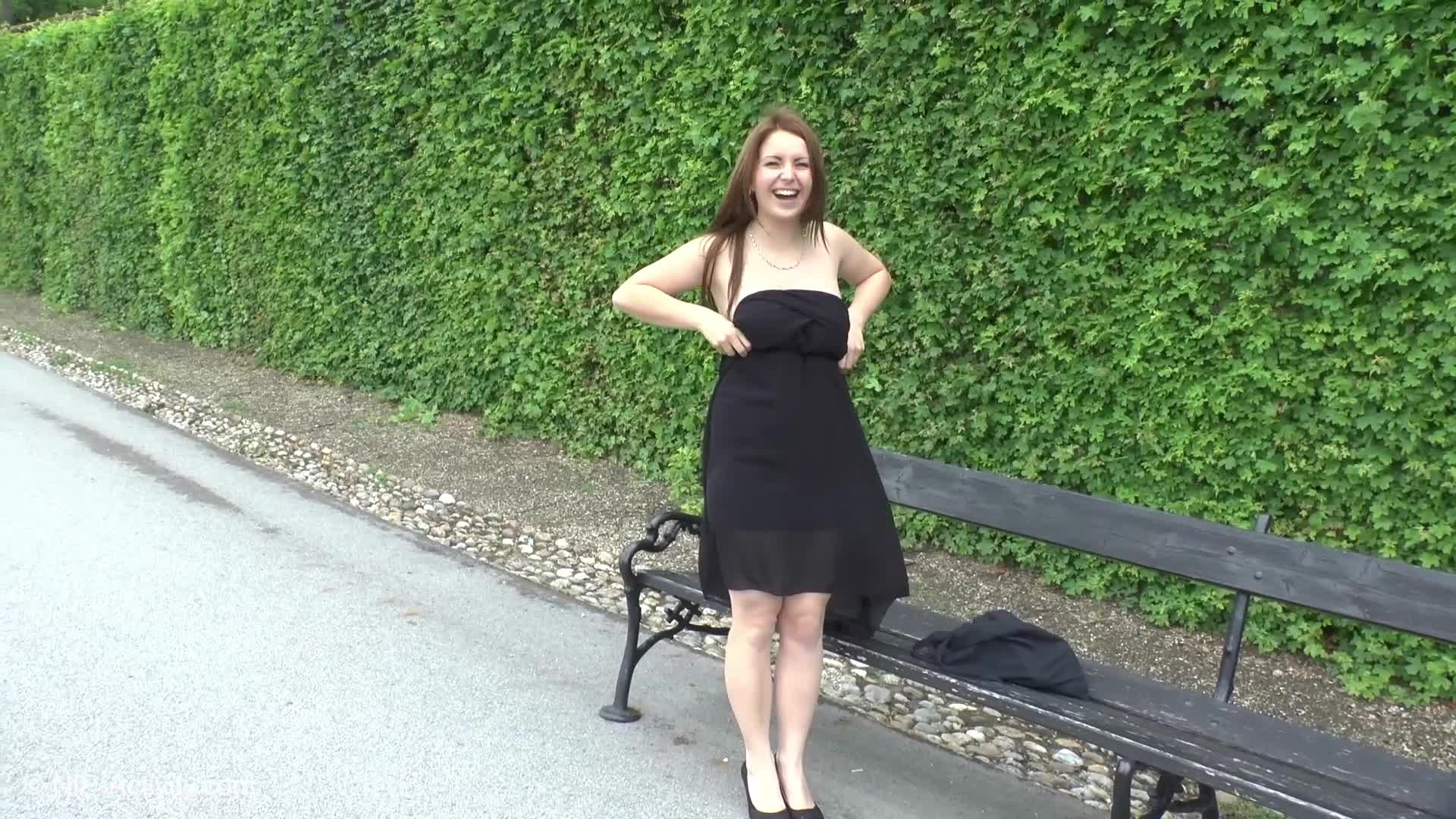 Shy girl goes for a stroll in a crowded park