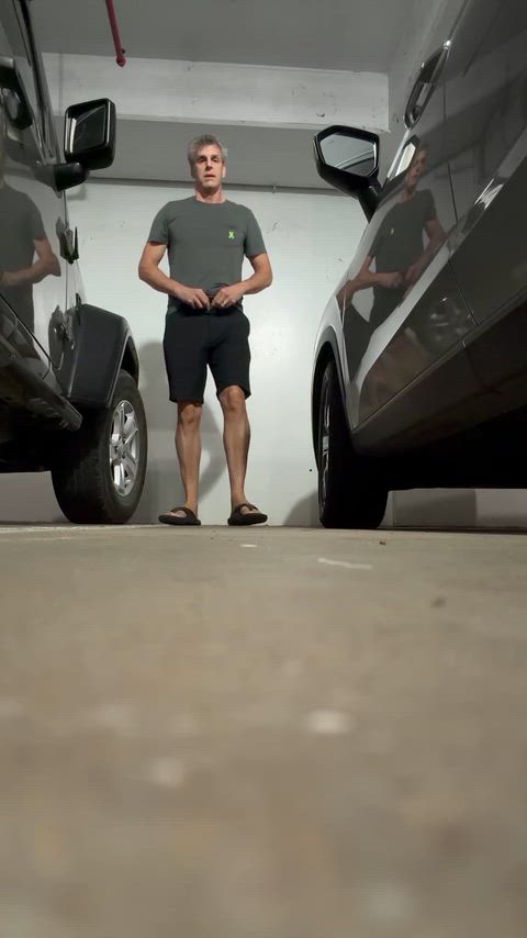 Pissing in a parking garage with people nearby