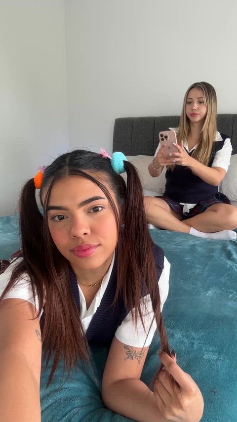 Two schoolgirls on the bed, waiting for you