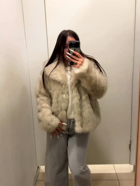 A cute angel is playing around in the fitting room