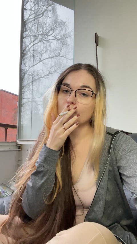 Glasses & no makeup. Smoking an all white cigarette🌷