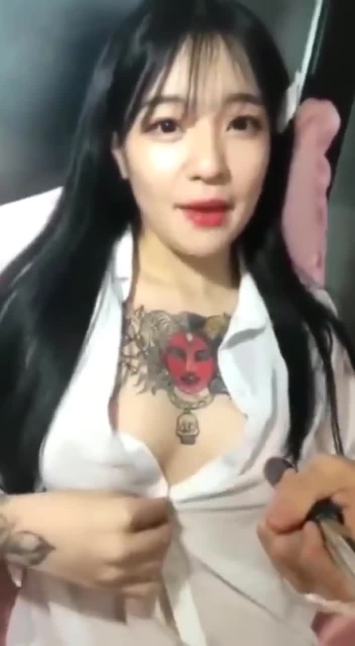 Showing off her tat and tits