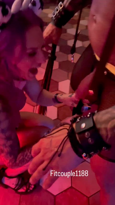 Giving a blowjob at rave in front of a busy bar