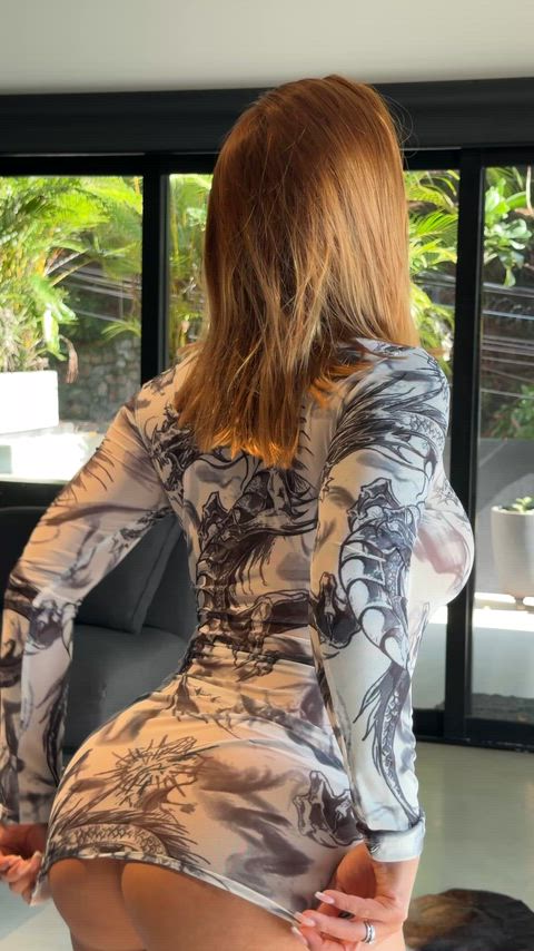 Dragon print dress hugging my curves… pulling it down for you