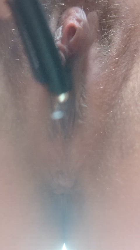 Pulling back the hood of my clitoris, exposing it and masturbating with a pen until I squirt on my phone underneath