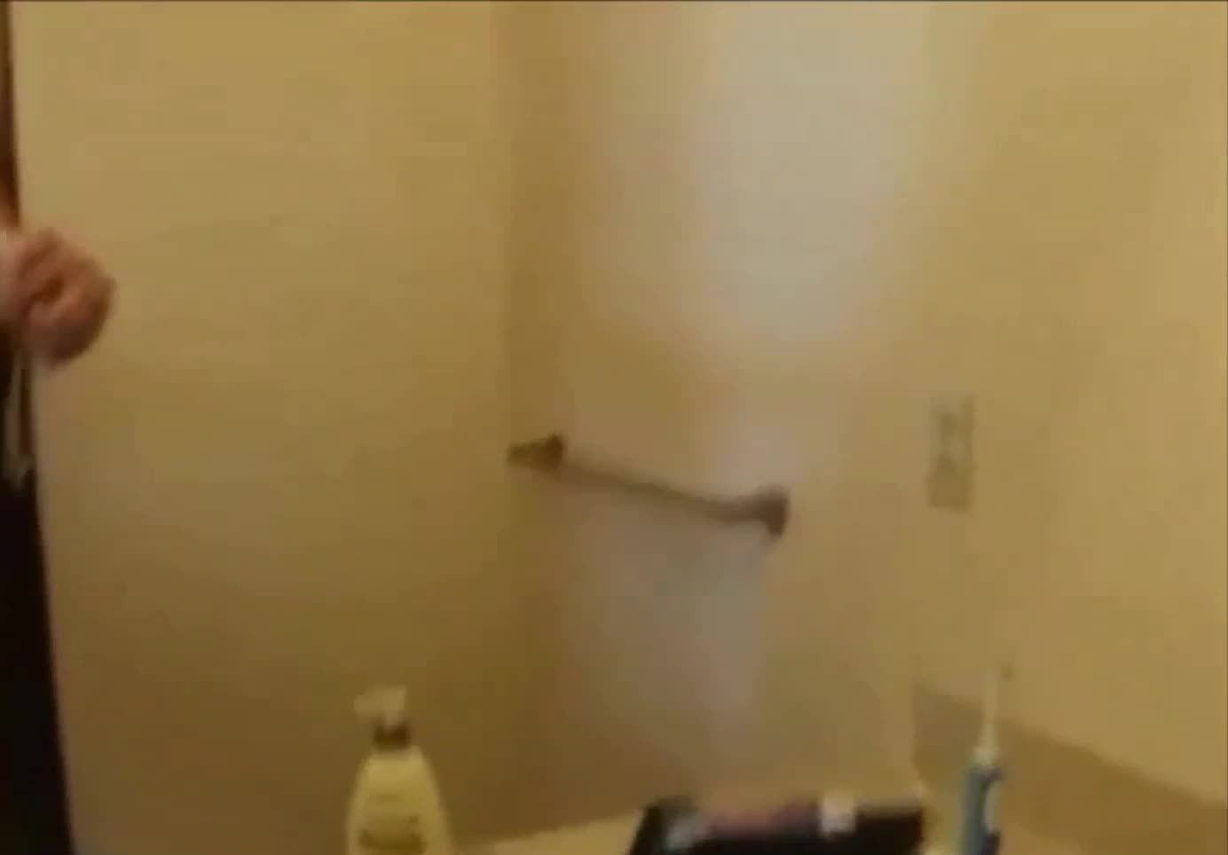 Handing her the camera while he slips it in