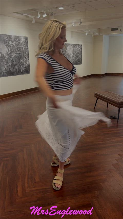In the library in a low cut shirt and skirt