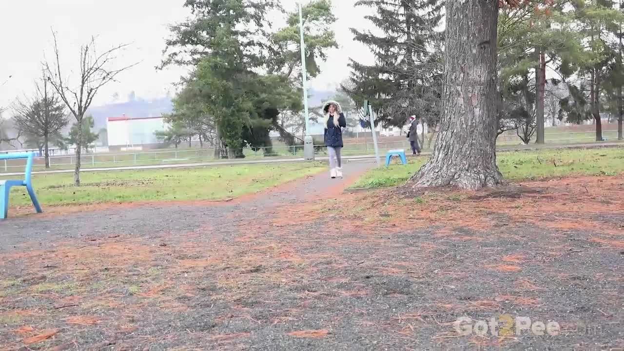 peeing behind a tree in the park