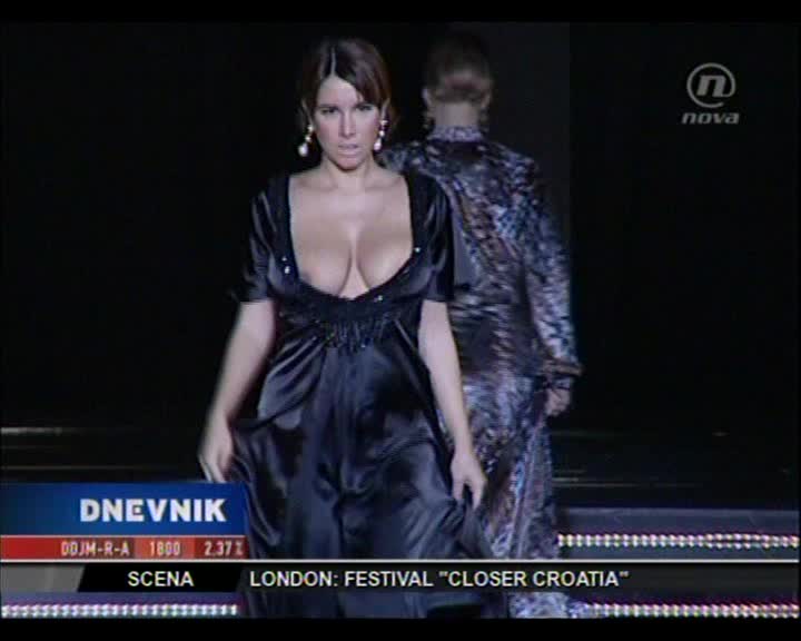 Nives Celsius has tits so big her dress can't contain them walking down the runway
